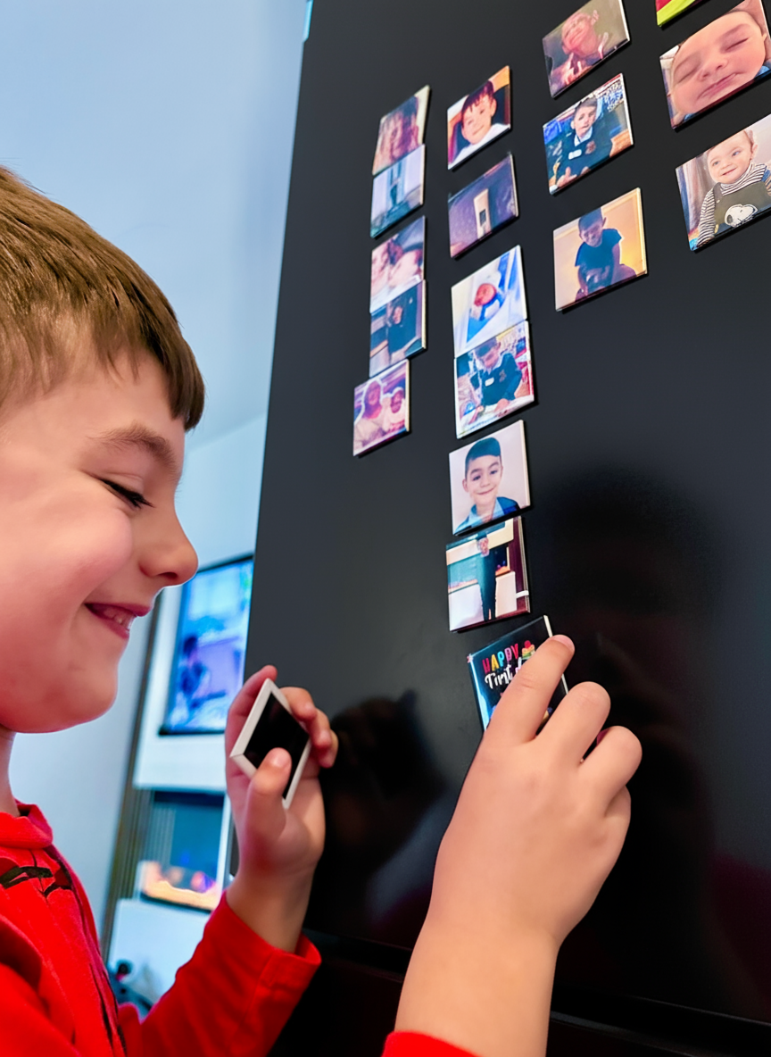 Boy Placing Magnets on Black Fridge